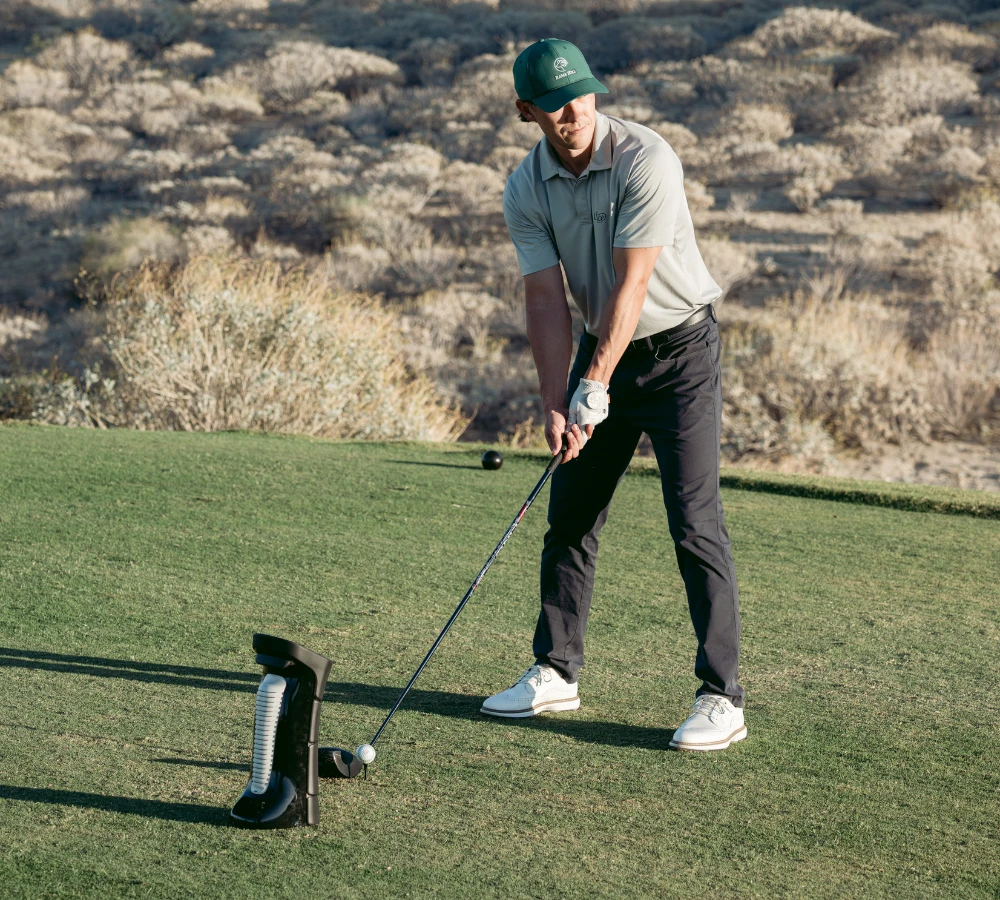 Golfer with Uneekor EYE MINI Launch Monitor